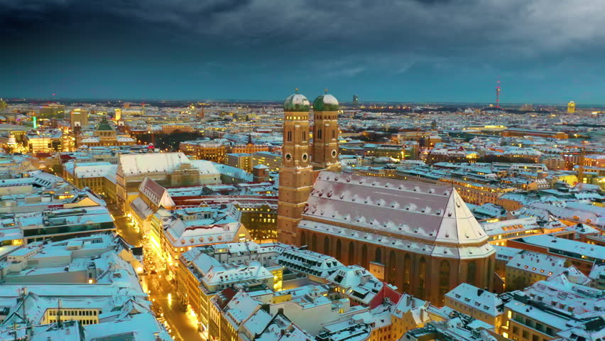 Munich aerial skyline view at night with snow winter time christmas, fly over marienplatz sqaure frauenkirche church and town hall, munich night drone video birds view. Munich Frauenkirche,Cathedral. Royalty-Free Stock Footage #1107892493