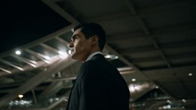 Calm employee admiring evening architecture back view. Formal suit businessman looking asides crossing night lights town closeup. Elegant man going to dark airport terminal. Journey tourism concept - Powered by Shutterstock - Get 15% off with code: PIKWIZARD15