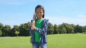 Portrait of serious lovely school age African American boy baseball hitter with baseball bat wearing eye black, ready to hit a shot and waiting for pitch while enjoying playing game on green field. - Powered by Shutterstock - Get 15% off with code: PIKWIZARD15