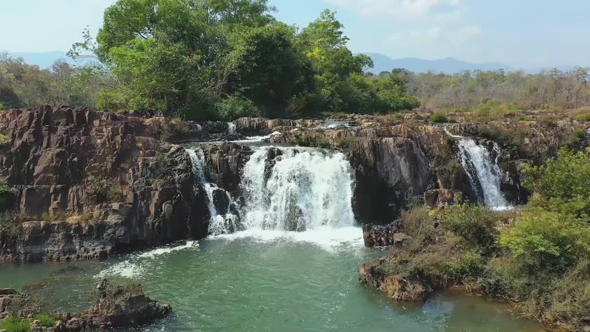 Aerial view of Tad Faed waterfall in Bolaven, Laos. Establishing drone shot of mountain river and forest in popular tourist destination of Boloven Loop. Royalty-Free Stock Footage #1107900793