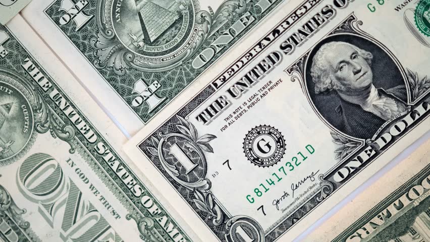 1 dollar bills money cash background US national currency top view. One American dollars banknotes lie surface rotating table close-up. Free currency exchange market. Royalty-Free Stock Footage #1107901579