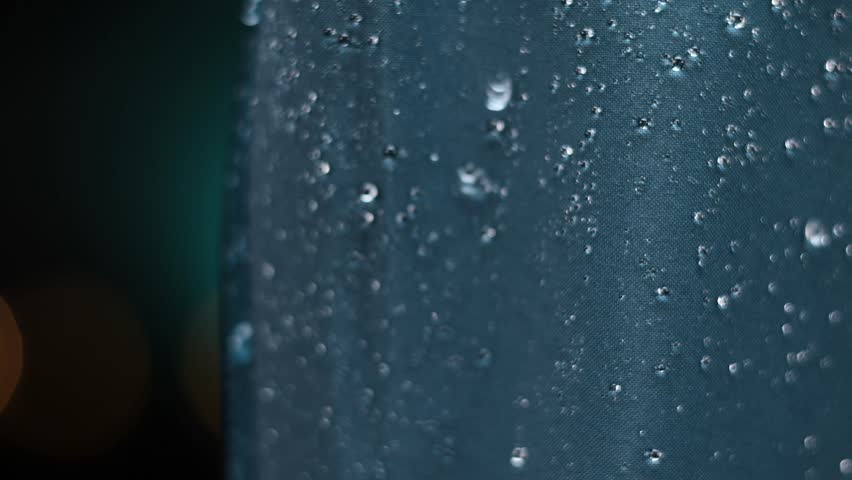 drops of water fall on a waterproof Gore-tex membrane fabric in slow motion Royalty-Free Stock Footage #1107901739