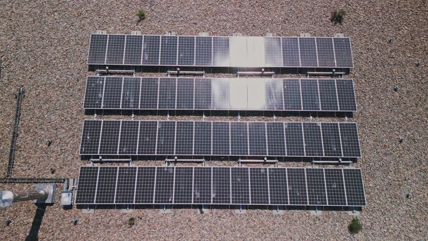 Drone shot of an array of solar panels installed on an apartment building in downtown Halifax, Canada. Drone view of a modern rooftop photovoltaic power system. Royalty-Free Stock Footage #1107905707