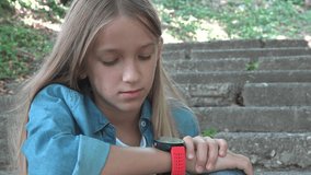 Girl Talking at Smartwatch in Park, Kid Playing Browsing Internet on Smart Watch, Child Using a Smartphone, Children use Devices