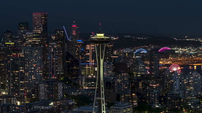 Aerial View Shot of Seattle at night evening, Washington USA, close, dark blue, circling left, Space Needle and watrefront