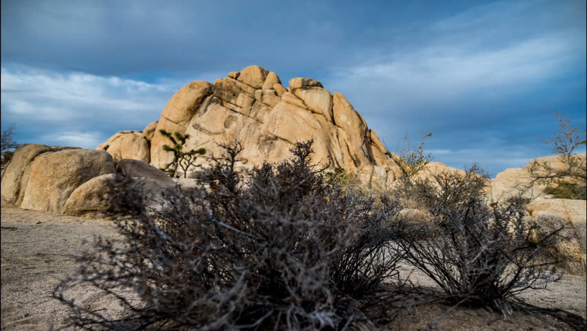 A time lapse of rock climbers climbing Old Woman Rock in Joshua Tree national park as the sun sets
