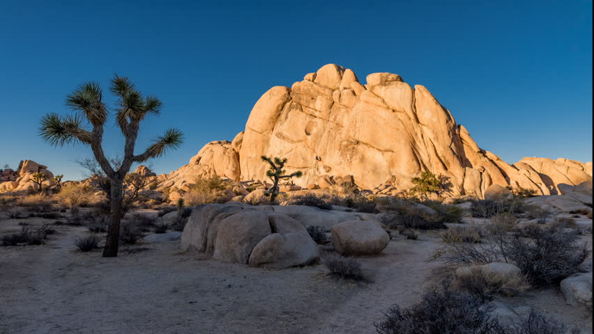 A time lapse of rock climbers climbing Old Woman Rock in Joshua Tree national park as the sun sets