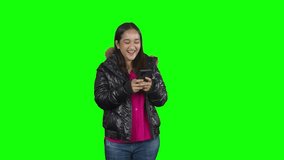 Happy Asian woman laughing while chatting on mobile phone Isolated on Green Screen - Chroma Key. 4k raw video footage 60 fps