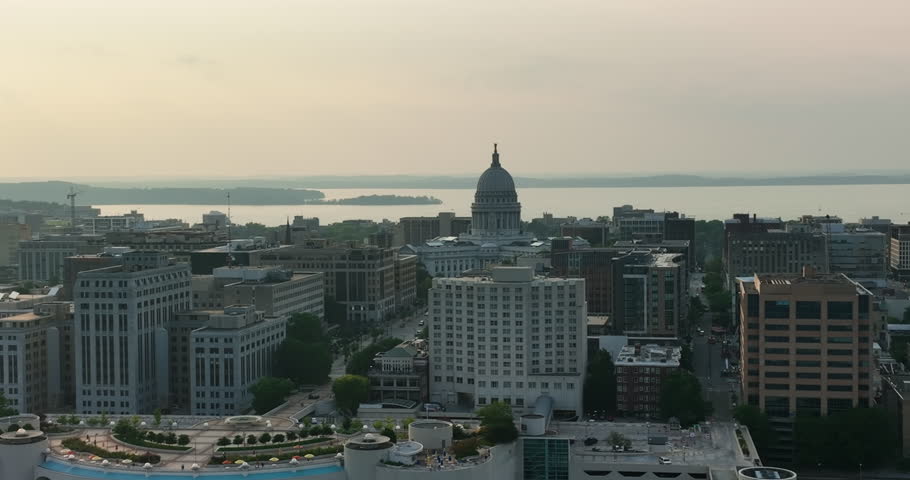 Aerial view of Madison city downtown buildings at sunset. Lake  Mendota in the background