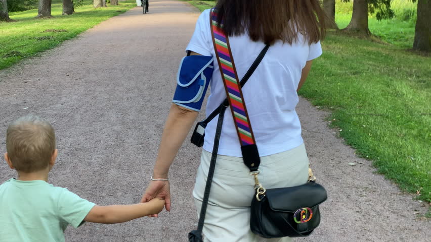 Holter monitor device and daily blood pressure recorder on human female body. Daily cardiogram monitoring. Health care and disease prevention