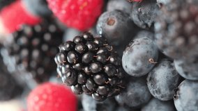 Vertical video of fresh raspberries, blackberries, blueberries. Healthy fruit berries. Pattern Fresh fruit snack. Summer Healthy eating and Vegan food concept. Vitamin K