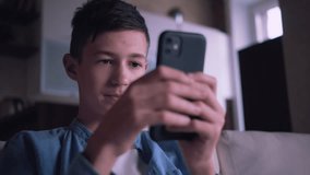 Digital Discovery: Young Boy Immersed in Smartphone Exploration from the Comfort of Home
