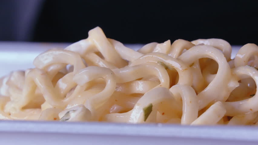 Gourmet Delights Unraveled: Mesmerizing Close-Up of Vermicelli Twirling Gracefully onto a Fork