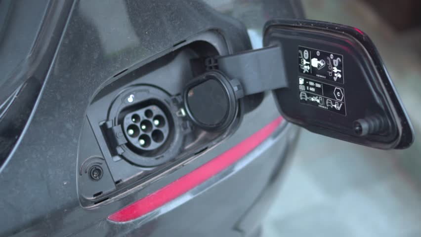 Open - close lid charging, Close up hand man  inserting plug into charging electric car.  Royalty-Free Stock Footage #1107930959