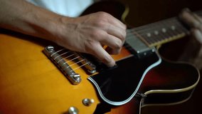 Closeup of person fingers strumming acoustic guitar strings. musician guitarist artist music concept