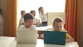 group of children study at home via laptops. business concept of modern training lifestyle and development. little kids are educated through the computer. two boys with laptops in the foreground