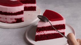 Close-up video captures the indulgent moment of tasting a sumptuous Red Velvet slice enriched with strawberry mousse, topped with vibrant strawberry jelly, using a spoon