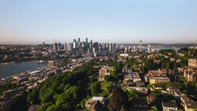 Aerial View Shot of Seattle, Washington USA, summer vibes, green trees, sun shining, Space Needle, great perspective from Queen Anne, tracking left