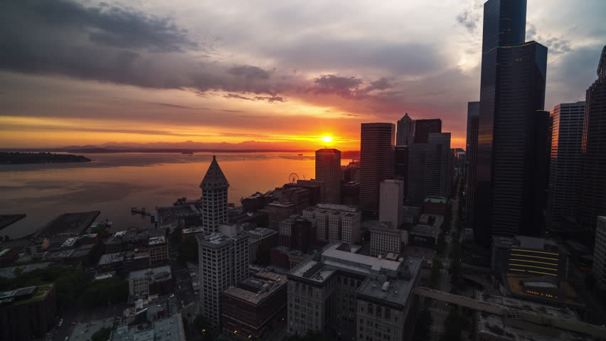 Moody magical sunset, Aerial View Shot of Seattle, Washington USA, downtown and waterfront, track backwards