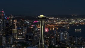 Aerial View Shot of Seattle at night evening, Washington USA, close, dark blue, circling left, Space Needle and waterfront