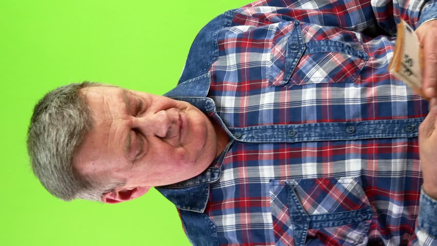 Senior man counting cash of 50 euro money banknotes and smiling pleased.