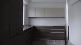 Stylish kitchen in apartment with modern interior, brown cupboard with wooden material, integrated household appliances and sink with faucet. Minimalist style at new kitchen. - Powered by Shutterstock - Get 15% off with code: PIKWIZARD15