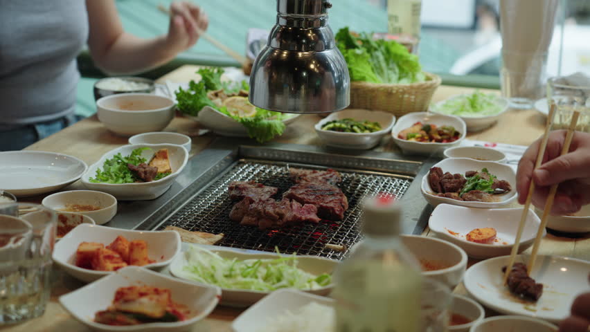 People enjoy a big meal at a Korean barbecue restaurant.