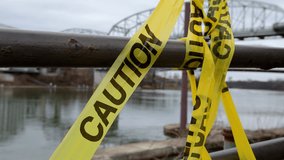 Caution tape at crime scene along river 4k - Powered by Shutterstock - Get 15% off with code: PIKWIZARD15