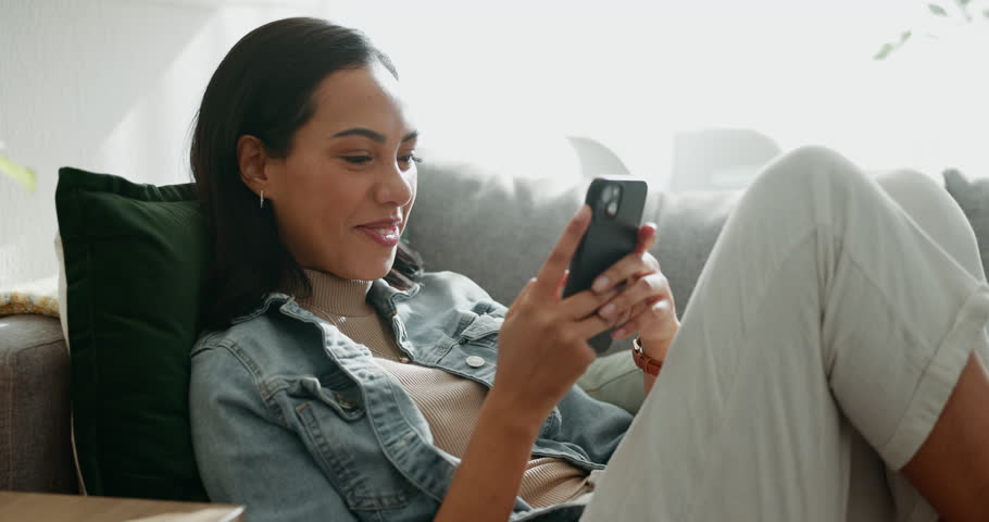 Woman, phone texting and home with social media post, networking and online on a sofa. Mobile app, happy message and typing on a living room couch with digital entertainment and tech in a house