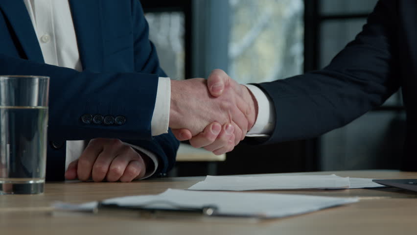Close-up two unrecognizable businessmen men negotiating at business meeting in office advisor lawyer financial expert consulting customer explaining make deal handshake shake hands successful contract