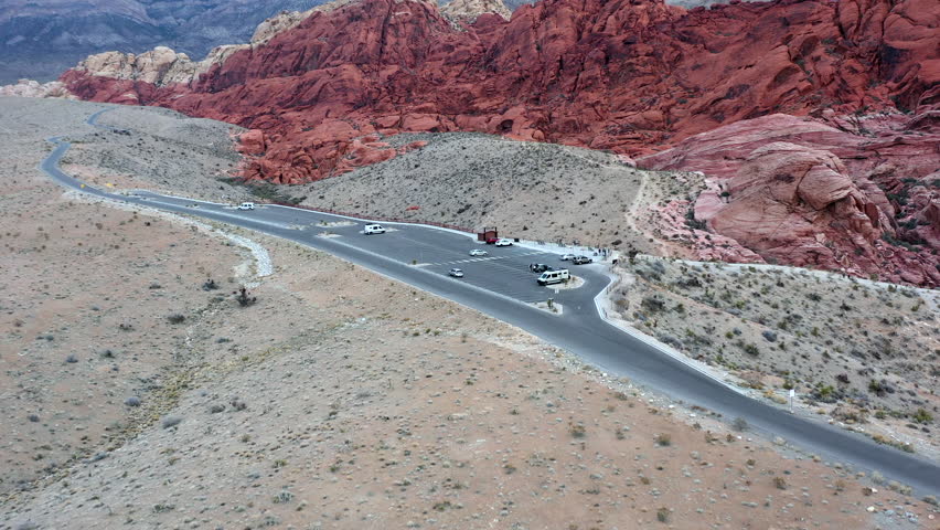 Drone passes over an overlook parking lot at Red Rock Canyon in Las Vegas, Nevada.
