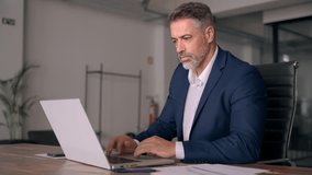 Portrait of mature Indian or Latin business man ceo trader using laptop computer, typing, working in modern office. Middle-age Hispanic smiling handsome businessman entrepreneur looking at laptop. - Powered by Shutterstock - Get 15% off with code: PIKWIZARD15