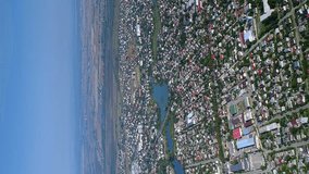 Vertical video. Aerial view of a Ukrainian city with large districts and private sector buildings. Ukraine.
