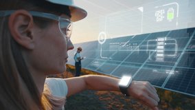 Female engineer smart watch chacking solar panels line status, looking at smartwatch. Male worker explore productivity of renewable resource with digital tablet. Green energy visualization. - Powered by Shutterstock - Get 15% off with code: PIKWIZARD15