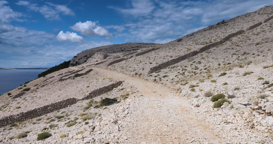 Camera moving along a trail on the island of Pag in slow motion