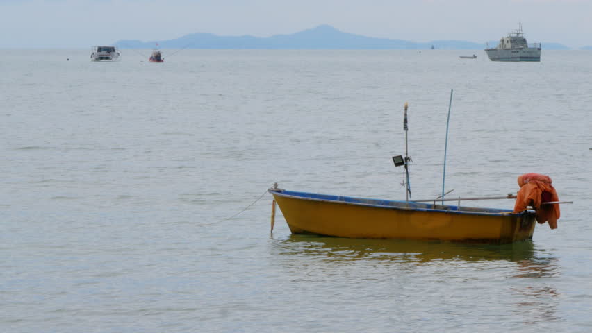 A Net Off is Thrown Into the Sea From a Small Fishing Boat