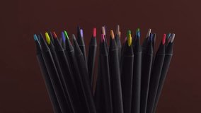 Collection of different multicolored school pencils used in drawing and coloring. Set of colorful pencils rotating on a brown background, macro. Back to school concept. Rainbow pencils closeup. Arts - Powered by Shutterstock - Get 15% off with code: PIKWIZARD15