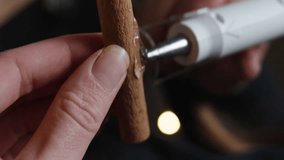 Vertical video. Handmade, New Year's installation, hot-glue cinnamon stick and pine branch.