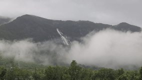 nature video background of the rain falling blurred,seeing the mist, Ngao waterfall on the high mountain in Ranong  of Thailand,the beauty of travelers from all over the world always come to see.