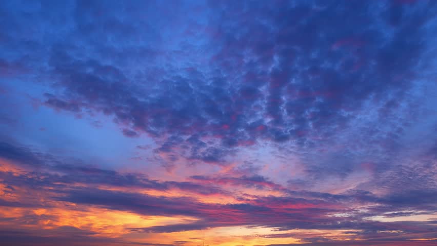 The sun ascends higher, the sky becomes a vivid tapestry of oranges, pinks, and yellows, casting a warm embrace over the entire scene. The clouds, now illuminated from above, take on a fluffy.
