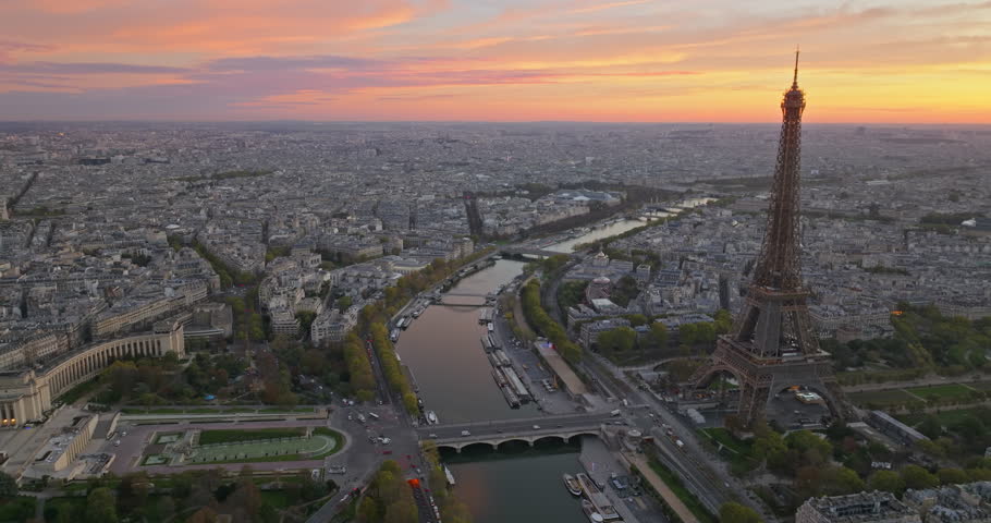 Beautiful view of famous Eiffel Tower in France with colorful twilight romantic sky. Wide establishing aerial morning sunrise or sunset of paris city center best travel destinations landmark in Europe Royalty-Free Stock Footage #1107982113