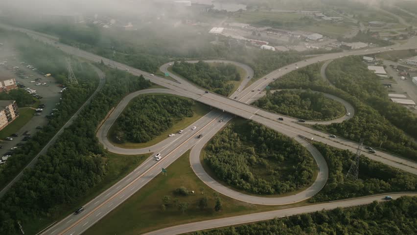 Aerial View of a Busy Freeway on a Foggy Day from the City of Dartmouth, Canada. Drone shot of Flyover or Overpass. Poor Visibility for Car Drivers, Driving in Fog at a Freeway Junction. 
