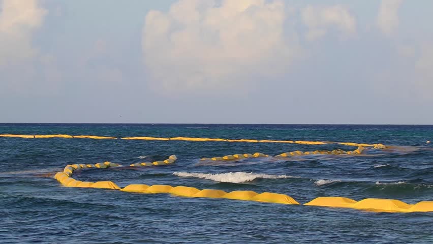 Beautiful blue and turquoise water waves ocean and yellow red orange Buoy buoys ropes and nets in the water of Playa del Carmen in Quintana Roo Mexico. Royalty-Free Stock Footage #1107985497