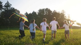 children run through the meadow in park with toys in their hands. happy family kid dream concept. a group of little lifestyle kids have fun together and play with flying kites toy airplane - Powered by Shutterstock - Get 15% off with code: PIKWIZARD15