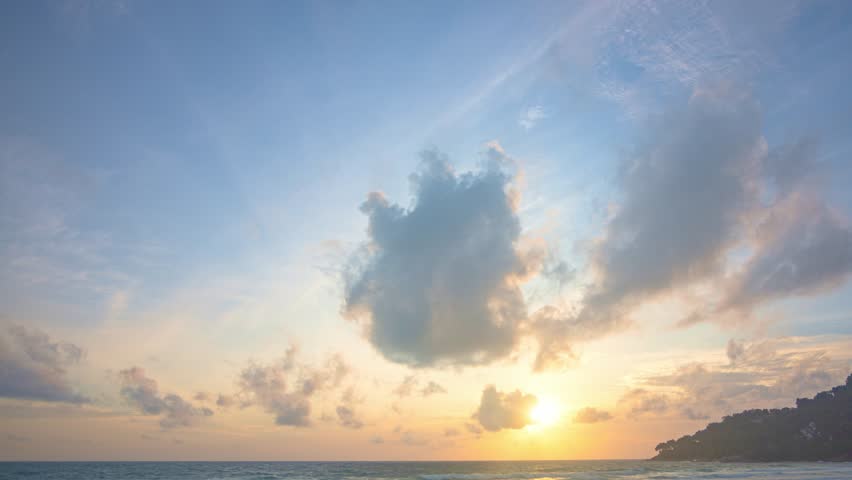 ..Timelapse stunning the sun shining through the clouds at the horizon..Scene of colorful yellow light through the clouds above the ocean..Gradient color. Sky texture, abstract nature background. | Shutterstock HD Video #1107992585
