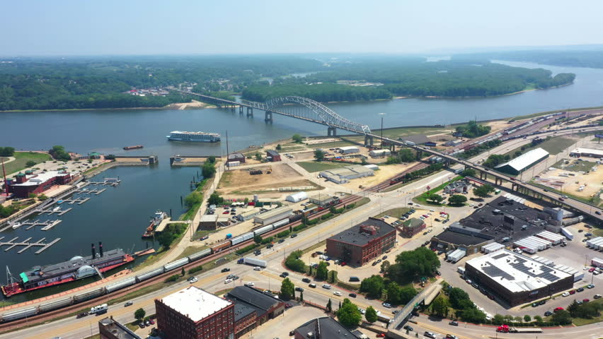 Aerial view following a riverboat leaving the Dubuque town at the Mississippi river, in sunny Iowa, USA