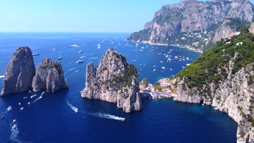 The Amalfi Coast is a breathtaking stretch of coastline in southern Italy, known for its vertiginous cliffs adorned with colorful villages, turquoise waters, and lush terraced gardens. Royalty-Free Stock Footage #1107998891