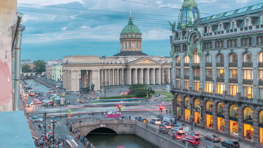 Kazan Cathedral and Singer House from a rooftop, timelapse captures the top view along Griboyedov Canal's waterfront. Traffic flows on the road below. Saint Petersburg, Russia