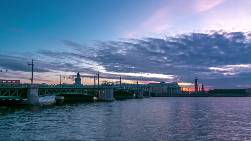 Palace Bridge day to night transition timelapse captures traffic, water mirror reflections. Birzhevoy bridge, Birzhevaya Square, Stock Exchange Building, and Rastralnye columns in Saint-Petersburg
