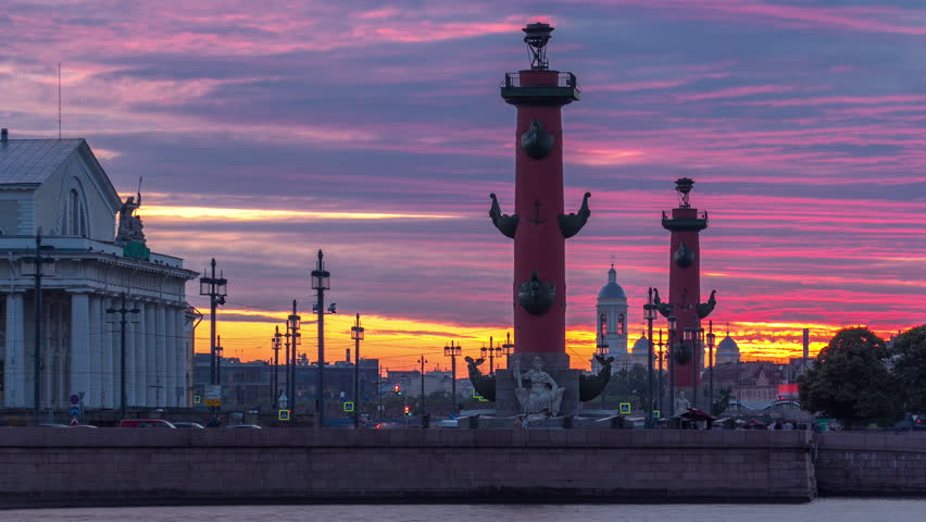 Sunset timelapse over Strelka - Spit of Vasilyevsky Island with Old Stock Exchange and Rostral Columns in Saint Petersburg, Russia, under a beautiful cloudy sky